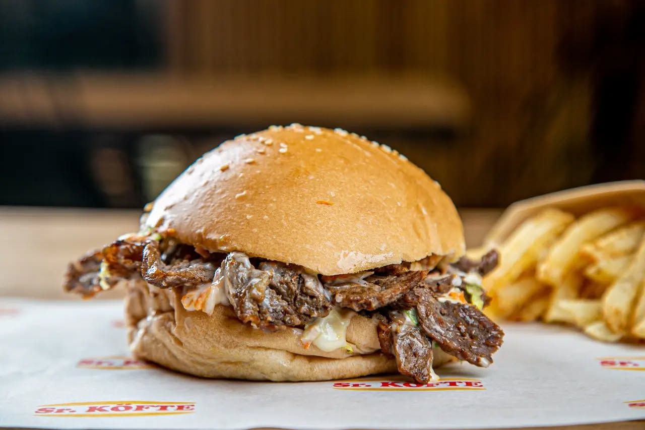 Friends enjoying burgers at a table